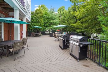 A patio with two bbq grills 
